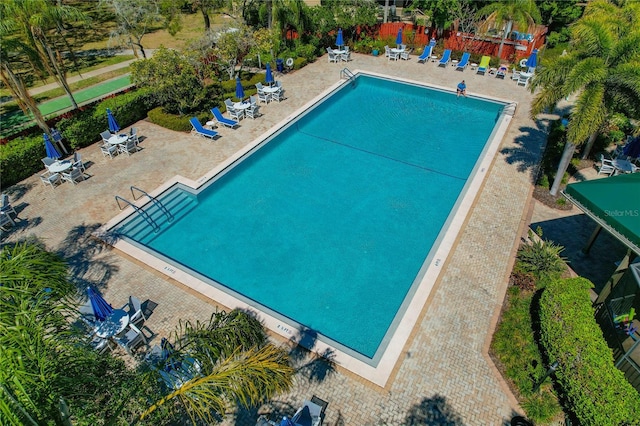 community pool featuring a patio area and fence