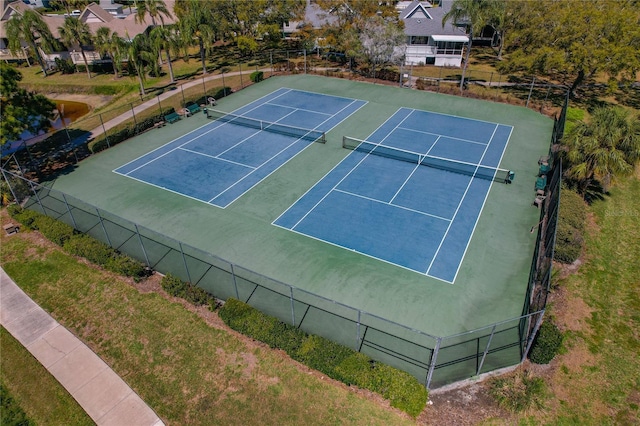 view of sport court featuring fence