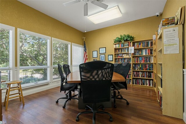 home office featuring a textured wall, wood finished floors, and a ceiling fan