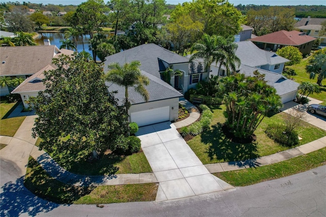 drone / aerial view featuring a water view and a residential view