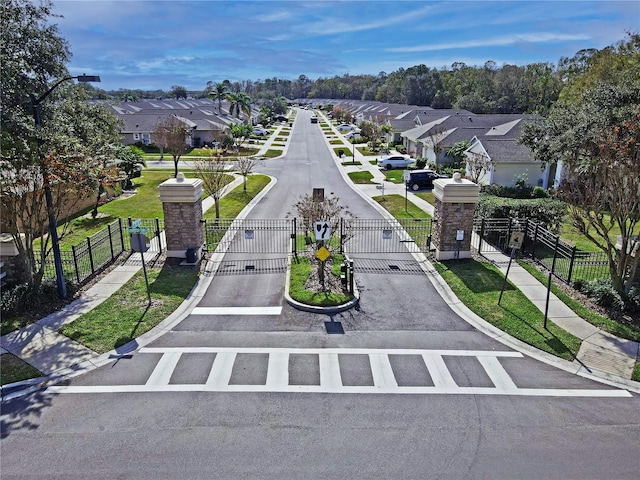 surrounding community featuring a gate, fence, and a residential view