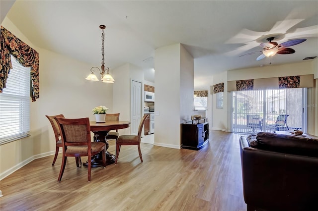 dining room with light wood-style floors, plenty of natural light, and baseboards