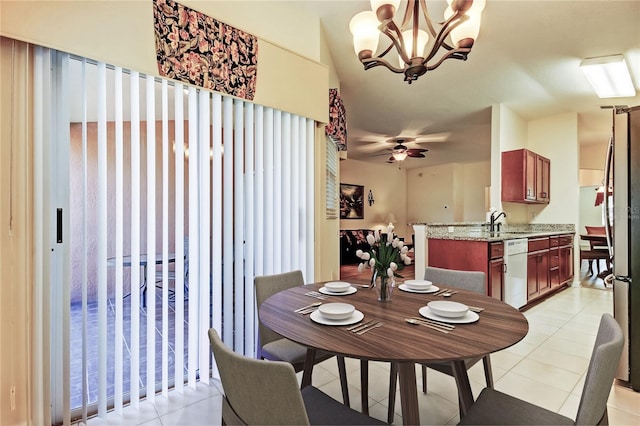 dining room with light tile patterned flooring and ceiling fan with notable chandelier