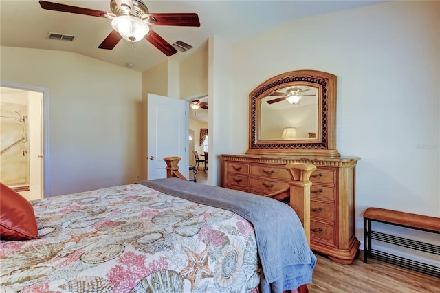 bedroom featuring vaulted ceiling, ceiling fan, light wood-type flooring, and visible vents