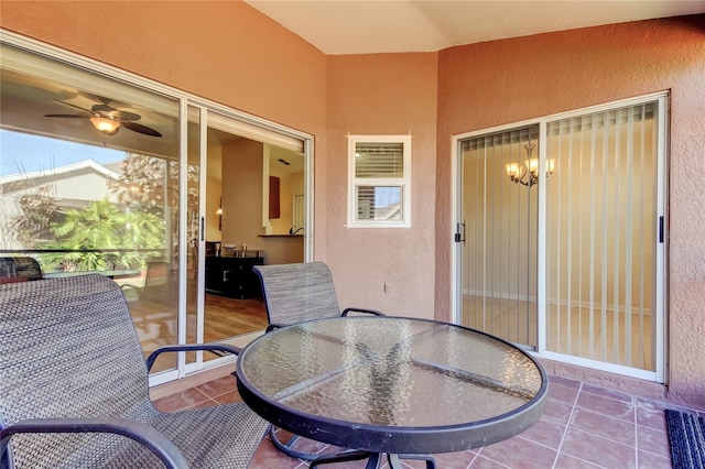 sunroom / solarium featuring visible vents and ceiling fan with notable chandelier