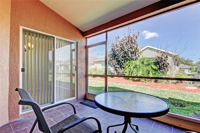 sunroom / solarium featuring lofted ceiling