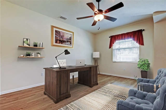 office area with light wood-type flooring, ceiling fan, and visible vents