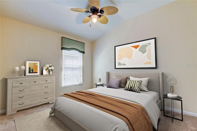 bedroom featuring a ceiling fan, lofted ceiling, light carpet, and baseboards