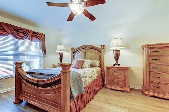 bedroom with light wood-style floors, ceiling fan, and baseboards