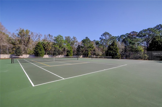 view of tennis court with fence