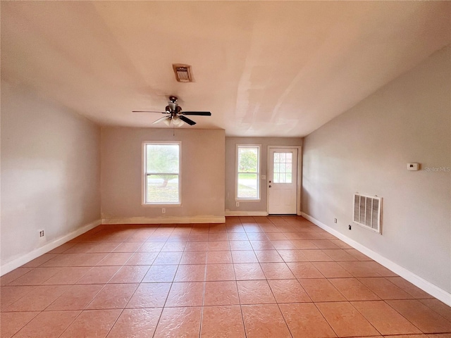 spare room featuring visible vents, baseboards, and light tile patterned flooring