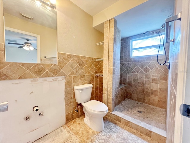 full bath with tile walls, visible vents, toilet, a tile shower, and tile patterned flooring