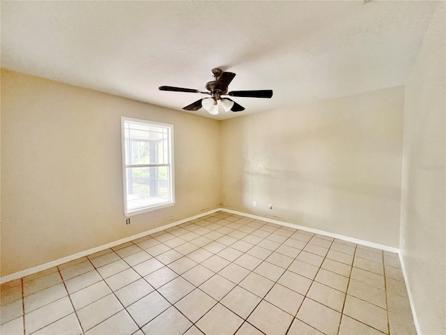 empty room with baseboards and a ceiling fan