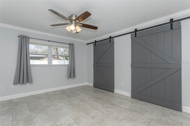 unfurnished bedroom with ceiling fan, a textured ceiling, a barn door, and ornamental molding