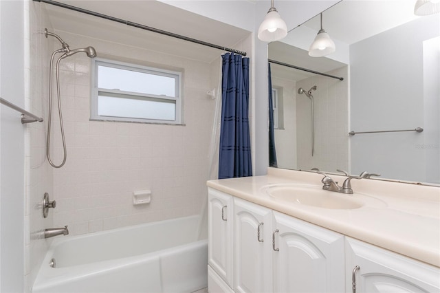 bathroom featuring shower / bath combo with shower curtain and vanity