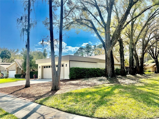 view of property exterior featuring a lawn, concrete driveway, and an attached garage