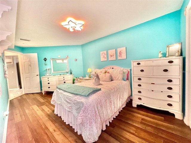 bedroom featuring visible vents and wood-type flooring