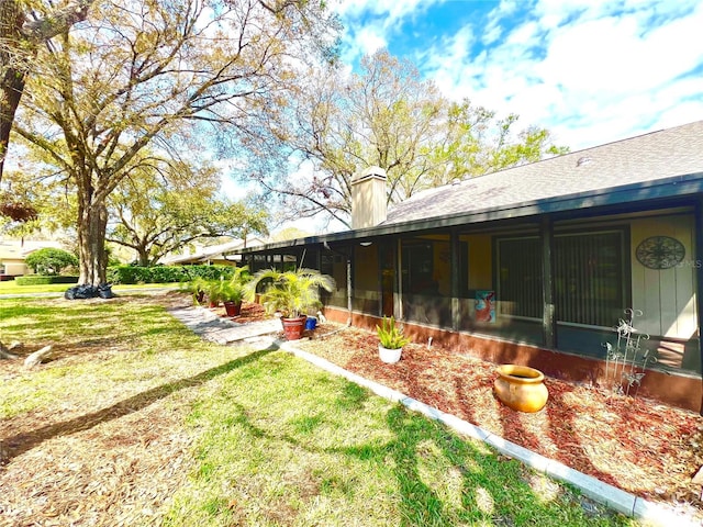 view of yard with a sunroom