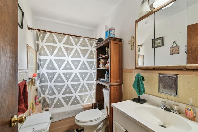 bathroom with shower / bath combo, vanity, toilet, and tile walls