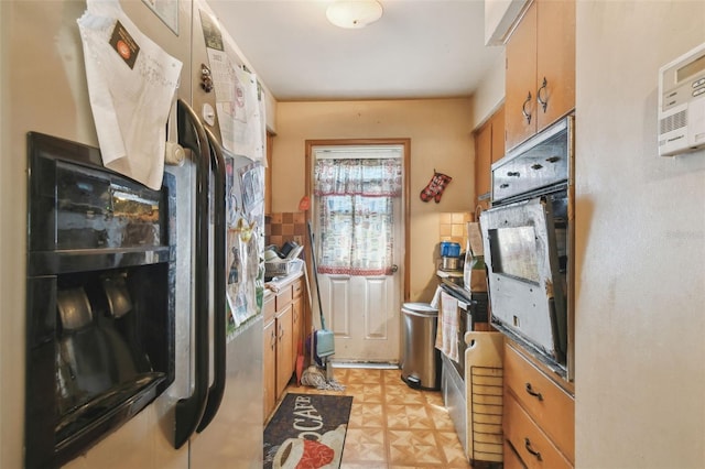 kitchen with brown cabinets, light floors, decorative backsplash, wall oven, and fridge with ice dispenser