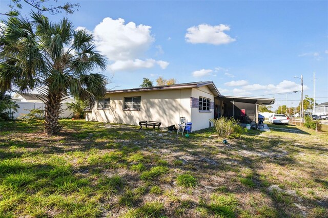 rear view of property with an attached carport