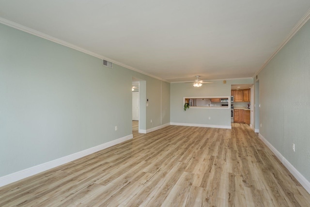 unfurnished living room featuring light wood-style floors, baseboards, visible vents, and ornamental molding