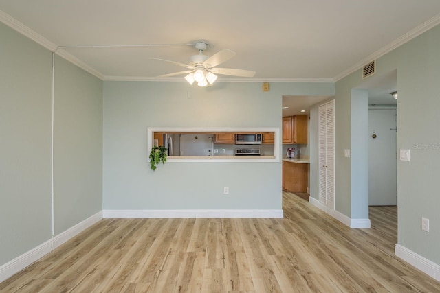 unfurnished living room featuring ornamental molding, visible vents, and light wood-style flooring