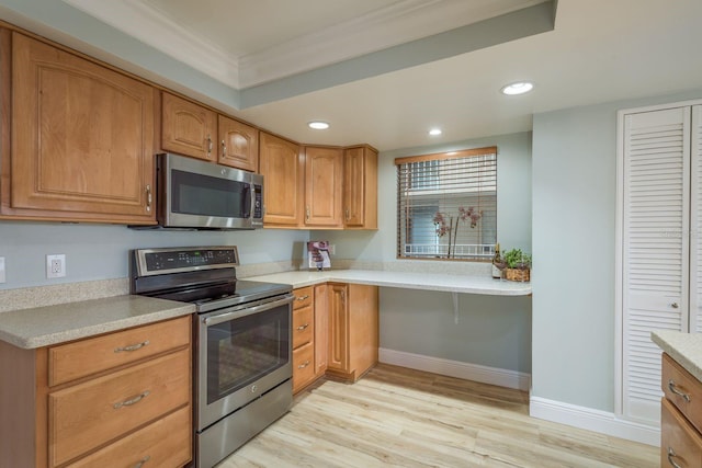 kitchen with recessed lighting, stainless steel appliances, baseboards, light countertops, and light wood finished floors