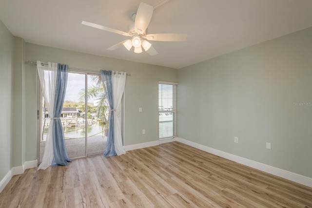 empty room featuring light wood-type flooring, ceiling fan, and baseboards