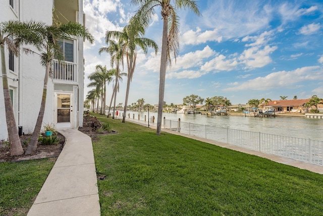 view of yard featuring a water view and fence