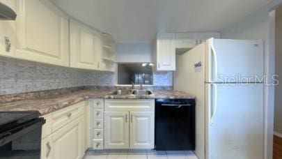 kitchen featuring a sink, exhaust hood, freestanding refrigerator, decorative backsplash, and dishwasher