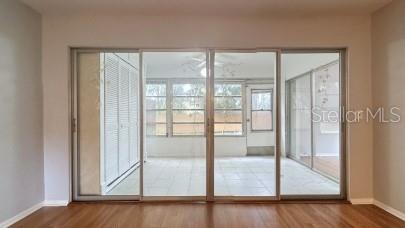 entryway with baseboards and wood finished floors