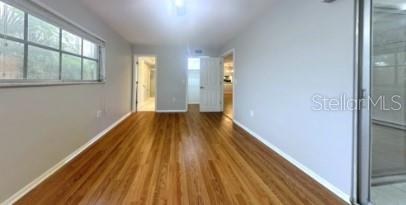 spare room featuring wood finished floors and baseboards