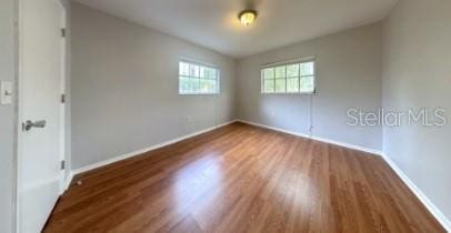 unfurnished room featuring baseboards and wood finished floors