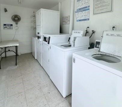 shared laundry area with washer and dryer and stacked washer and clothes dryer