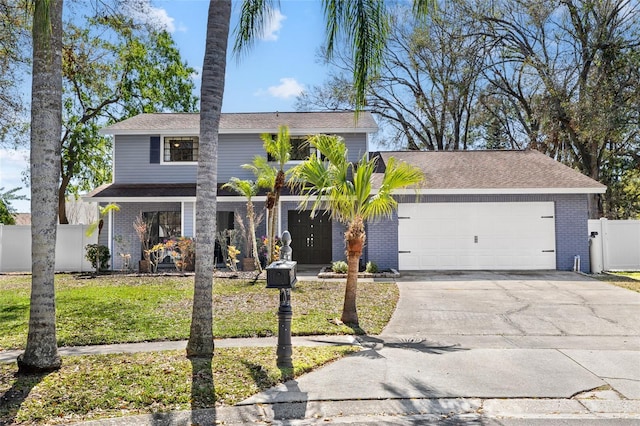 view of front of property with an attached garage, driveway, fence, and brick siding