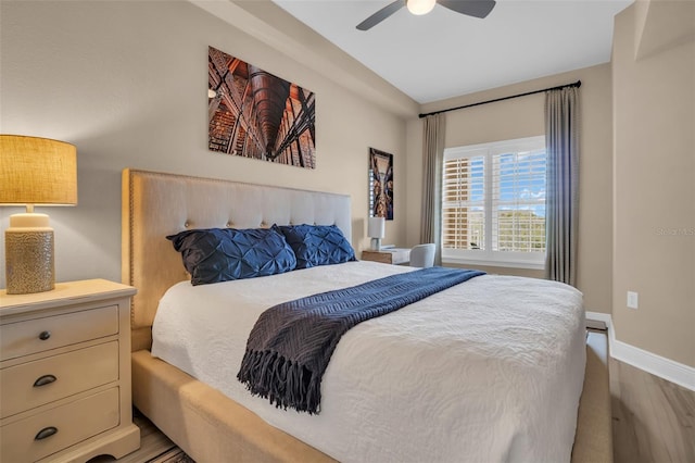 bedroom featuring a ceiling fan, wood finished floors, and baseboards