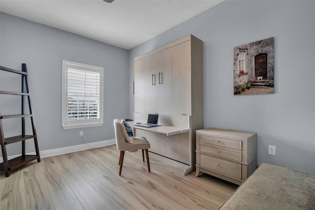 office area featuring light wood-style flooring and baseboards