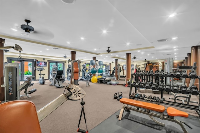 exercise room featuring recessed lighting, visible vents, a raised ceiling, and a ceiling fan