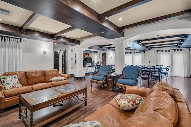 living room with visible vents, beamed ceiling, wood finished floors, and decorative columns