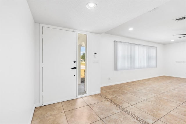 entryway with ceiling fan, light tile patterned flooring, recessed lighting, visible vents, and baseboards