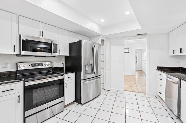 kitchen featuring light tile patterned floors, stainless steel appliances, white cabinetry, and recessed lighting