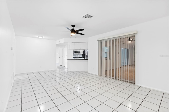 unfurnished living room featuring visible vents, a ceiling fan, and light tile patterned flooring