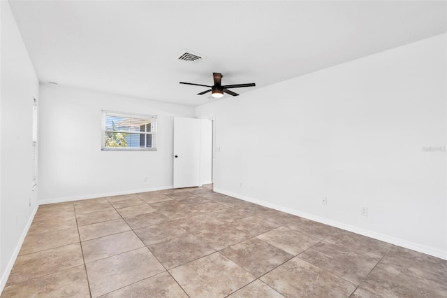 empty room with light tile patterned floors, baseboards, visible vents, and a ceiling fan