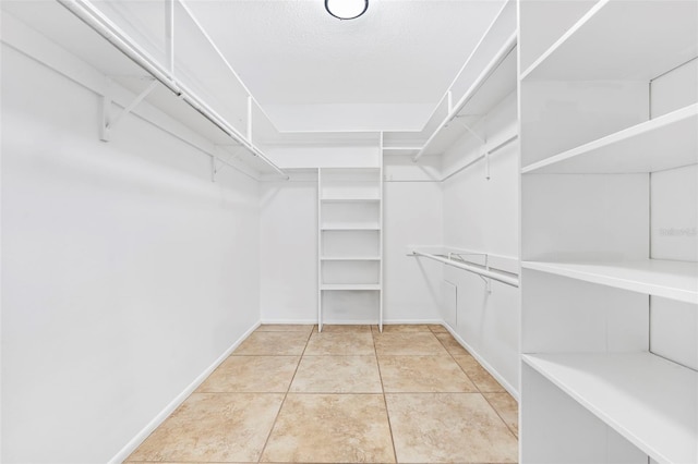 spacious closet featuring tile patterned flooring