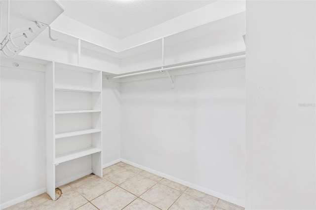 walk in closet with tile patterned floors