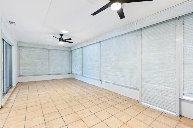 unfurnished sunroom with ceiling fan and visible vents