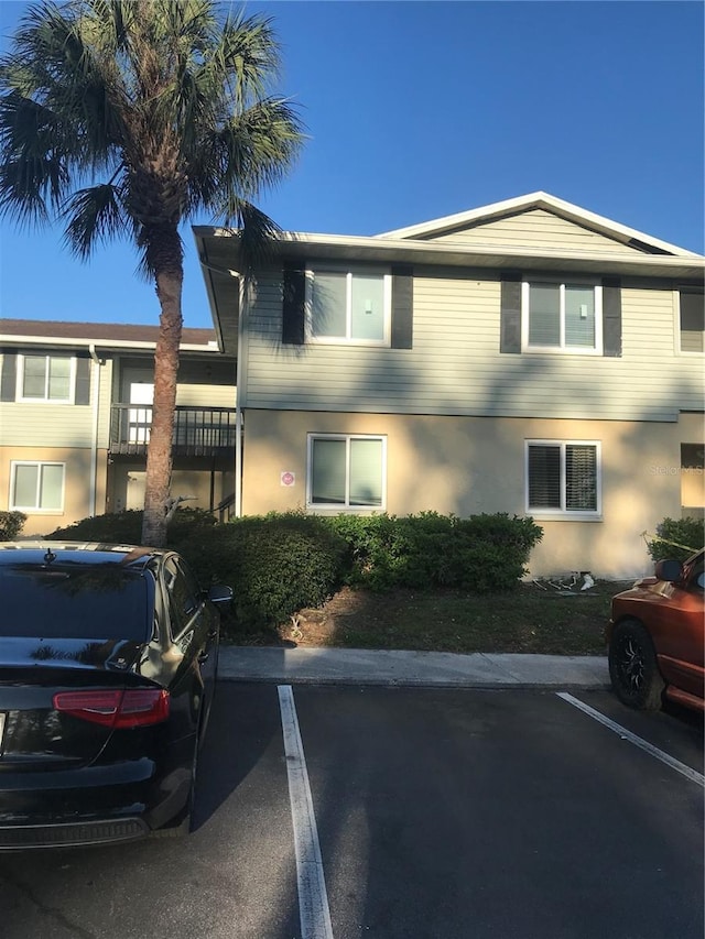 view of front of property featuring stucco siding and uncovered parking