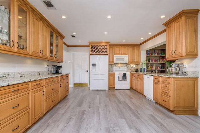 kitchen featuring light wood-style flooring, white appliances, visible vents, light stone countertops, and crown molding