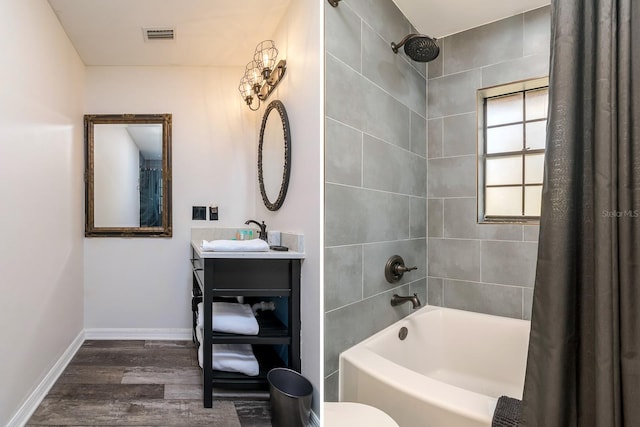 full bathroom featuring visible vents, baseboards, shower / tub combo with curtain, wood finished floors, and vanity